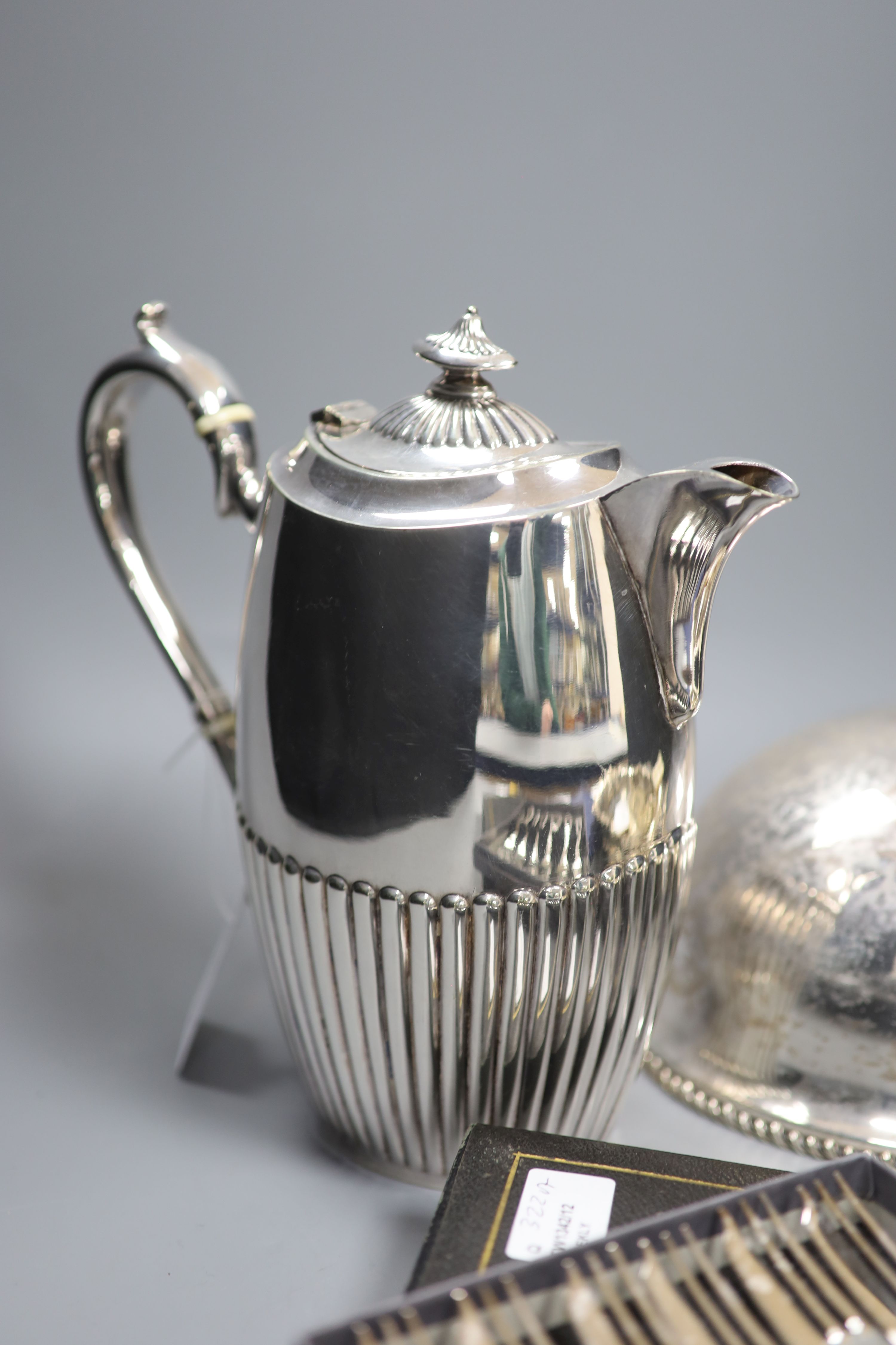 A cast white metal bowl and a collection of plated items, including a hot water pot, meat cover, cased flatware etc.